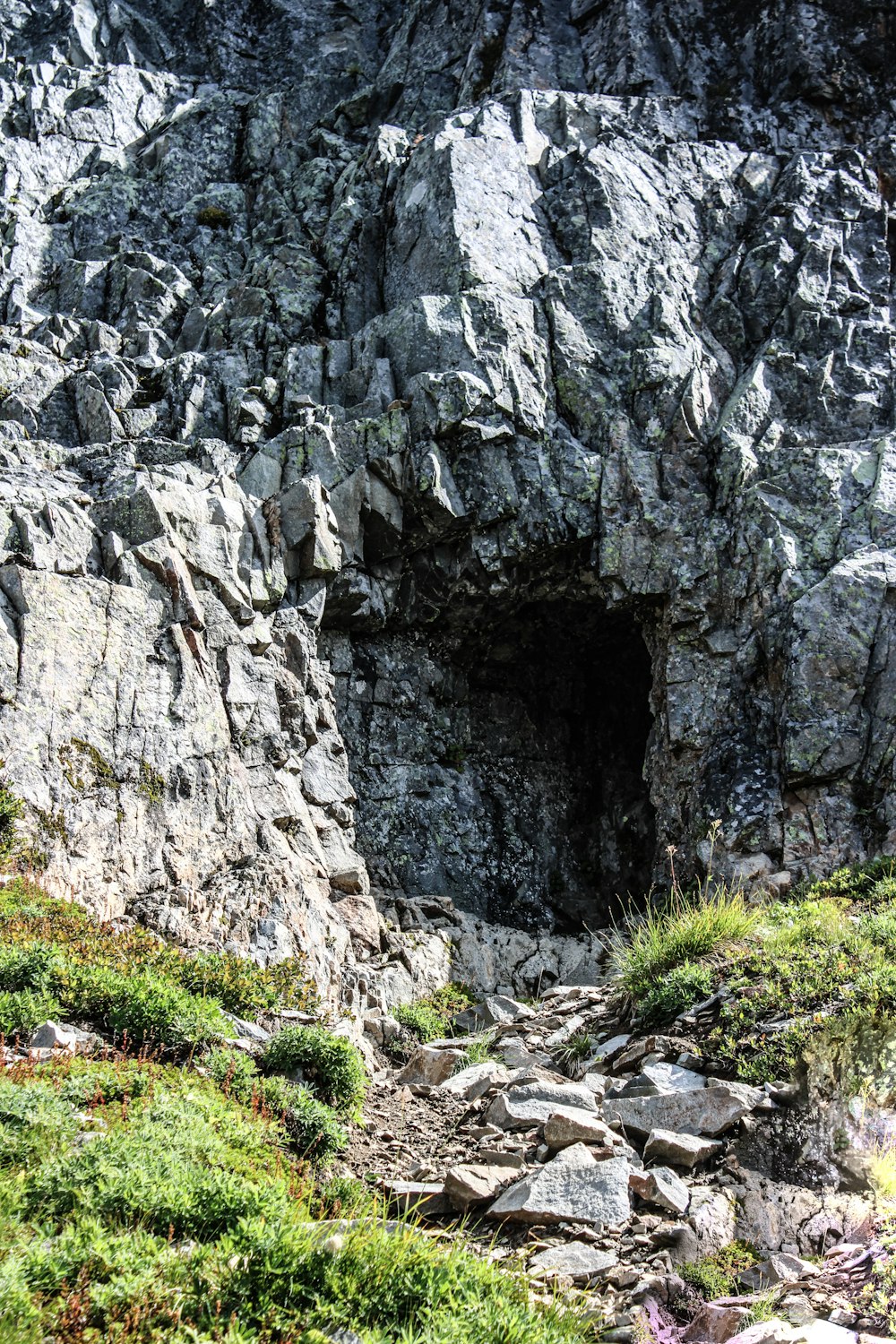 a rocky outcropping with a small opening in the middle