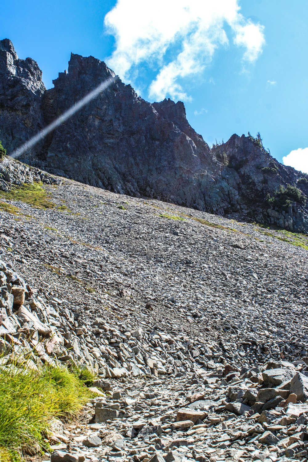 a rocky mountain slope with grass and rocks