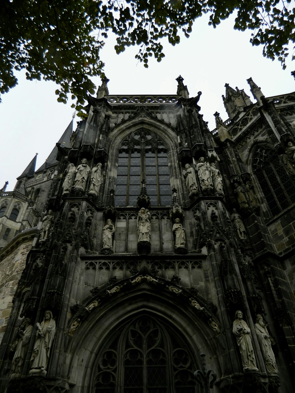 a very tall building with statues on the front of it