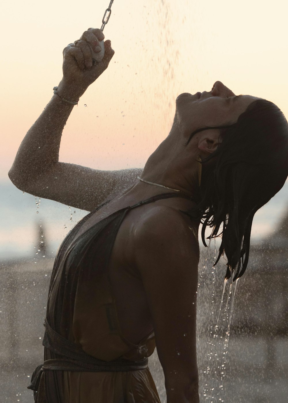 a woman standing under a shower of water
