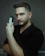 Close-up of a confident man with a crisp fade haircut and perfectly groomed beard in a sleek barber studio setting.
