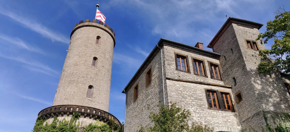 a tall tower with a flag on top of it