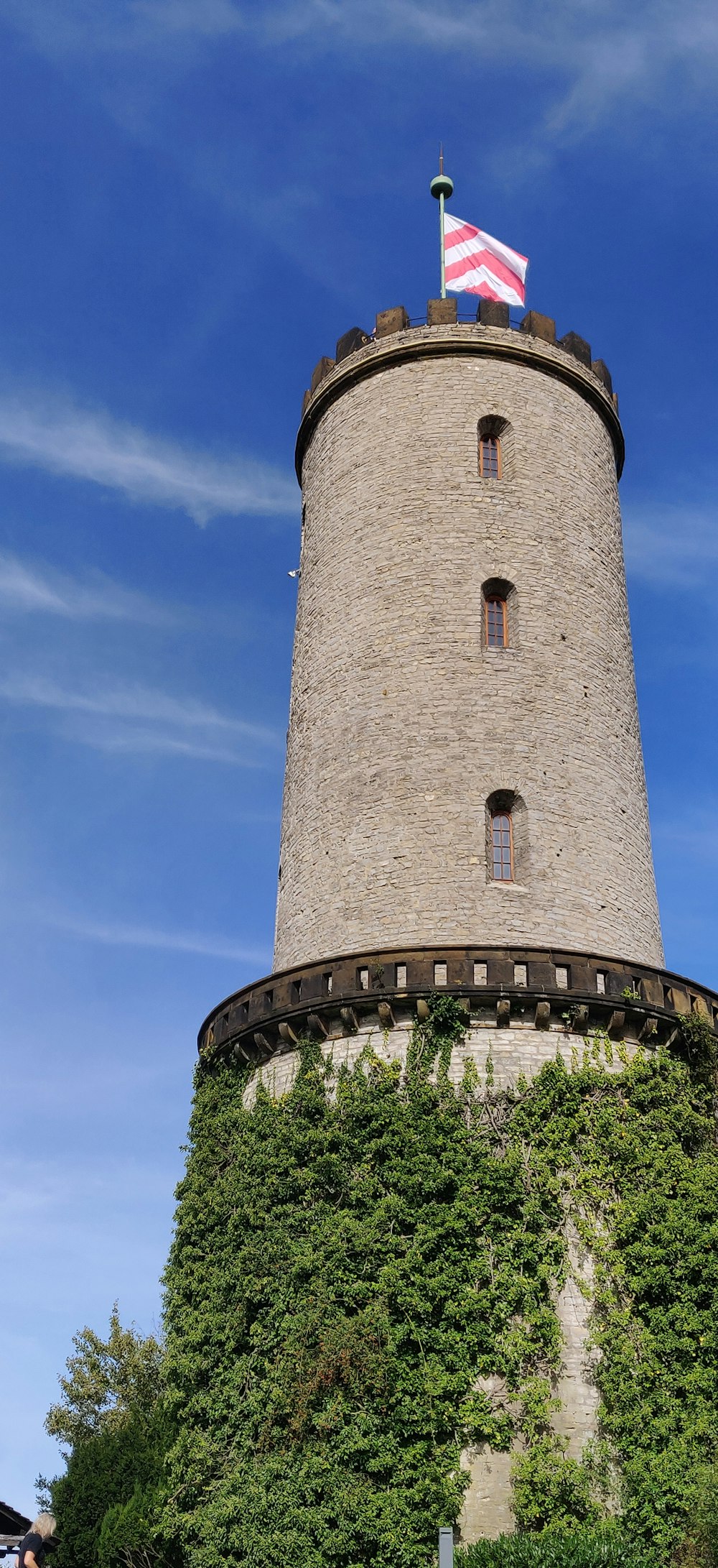 a tall tower with a flag on top of it