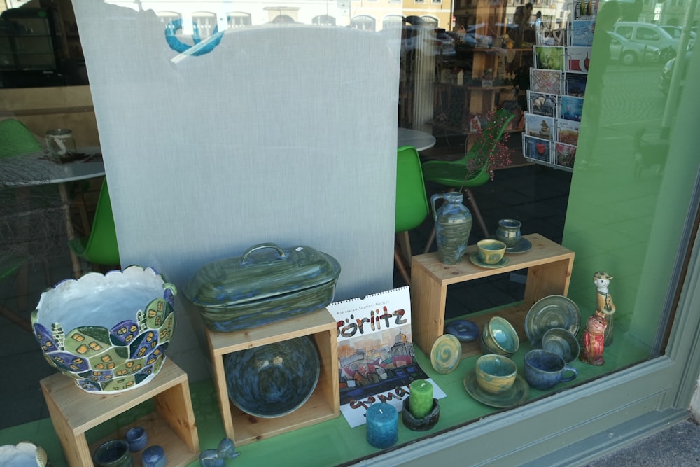a window display of pottery in a store
