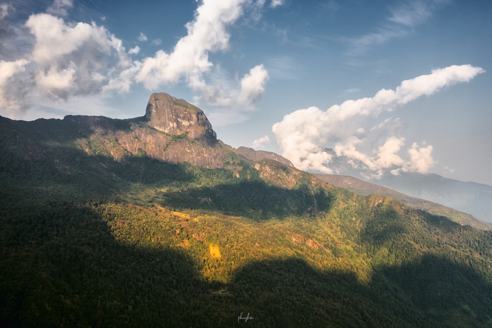 a view of a mountain with clouds in the sky