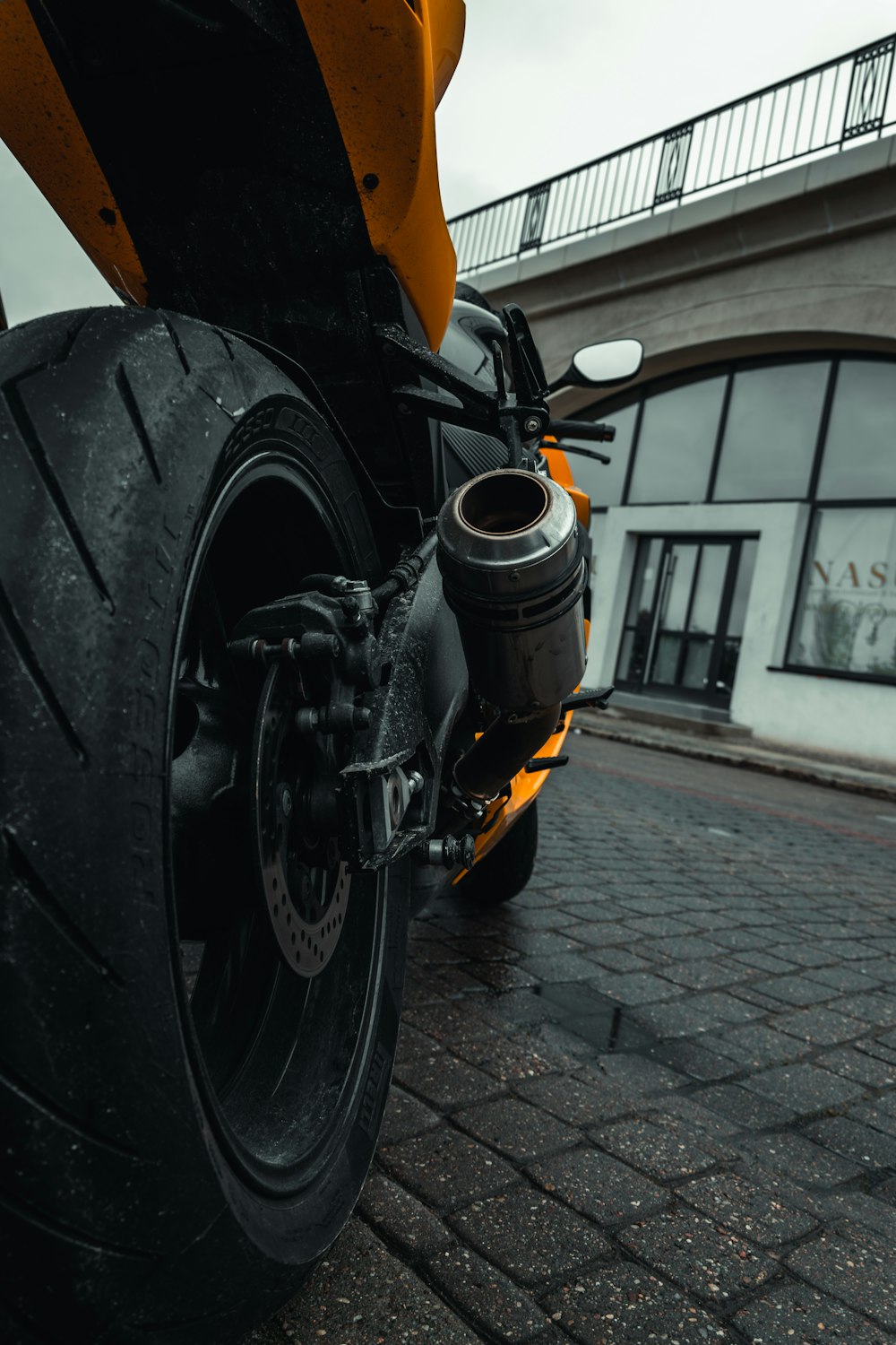 a close up of a motorcycle on a brick road