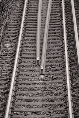 a black and white photo of a train track