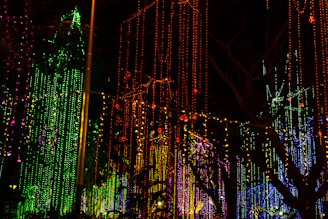 A vibrant string of colorful LED fairy lights draped over a festive outdoor patio.