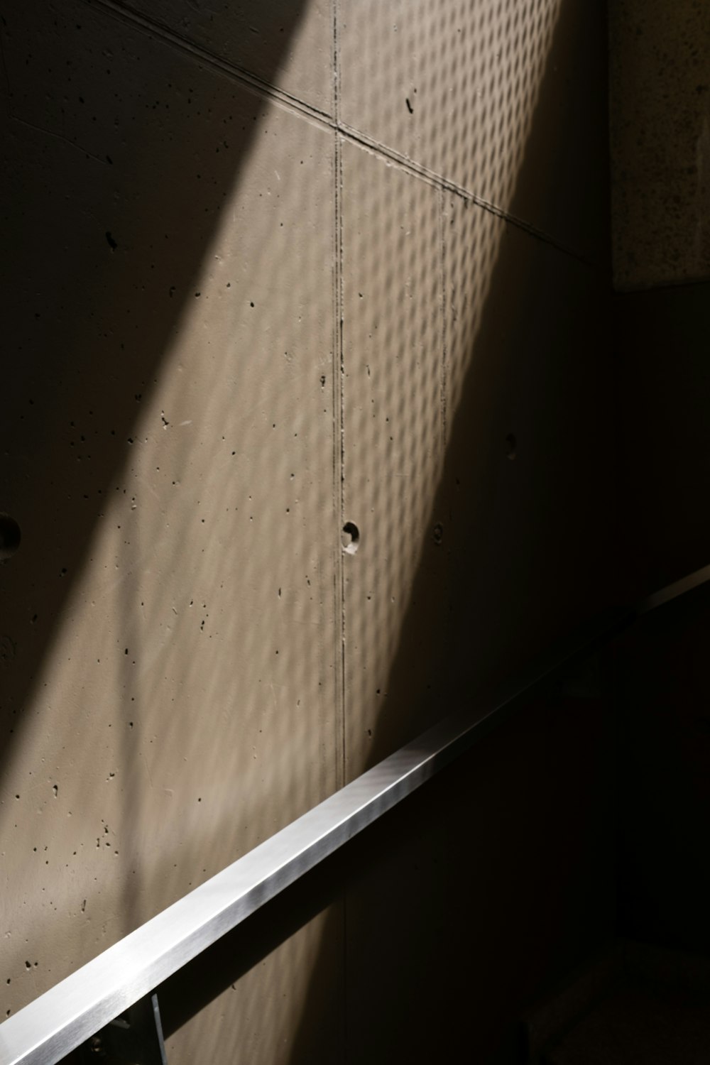 a metal hand rail in a dimly lit room