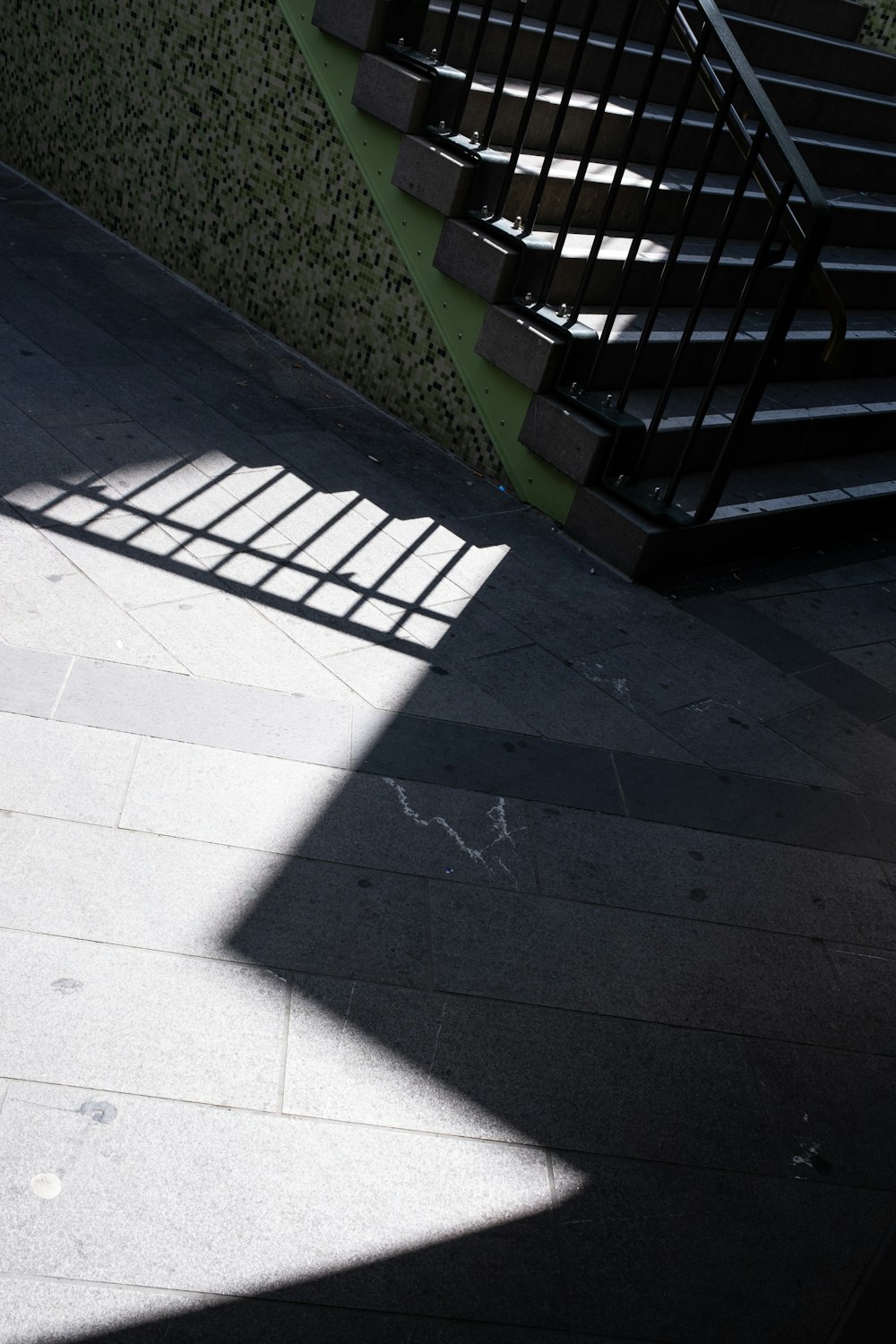 the shadow of a stair case on the ground