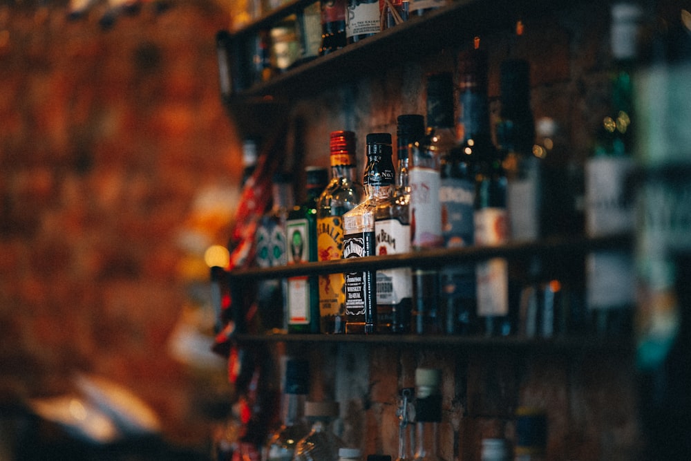 a shelf filled with lots of bottles of alcohol