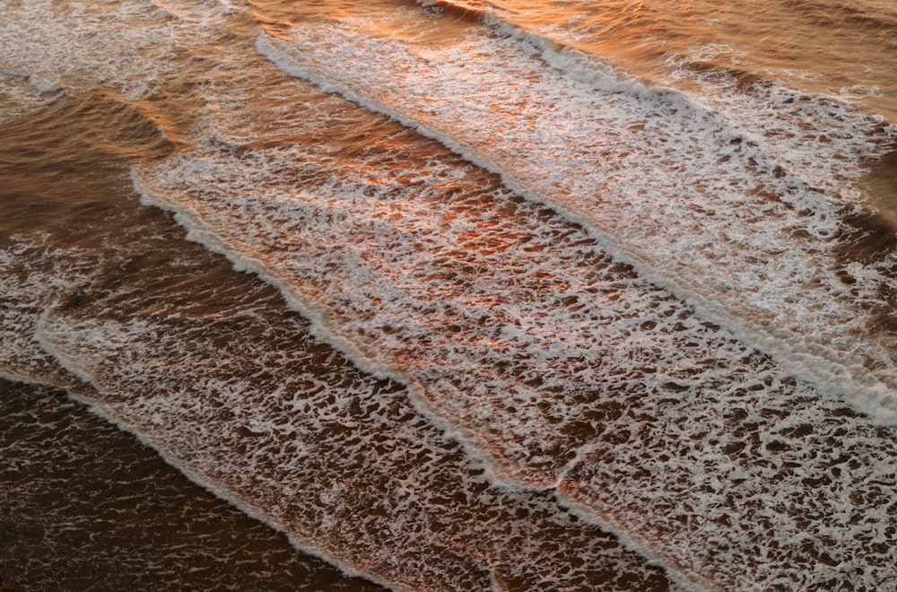 a surfer riding a wave on the beach