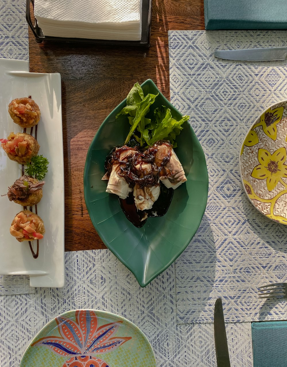 a table topped with plates of food and utensils