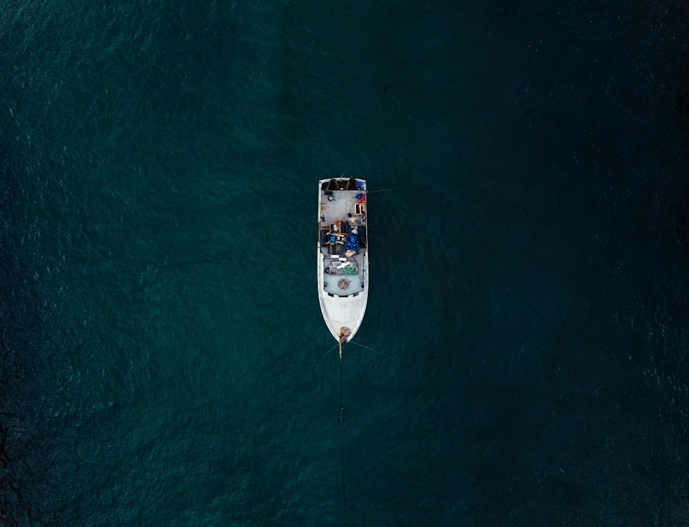 a small boat floating on top of a large body of water