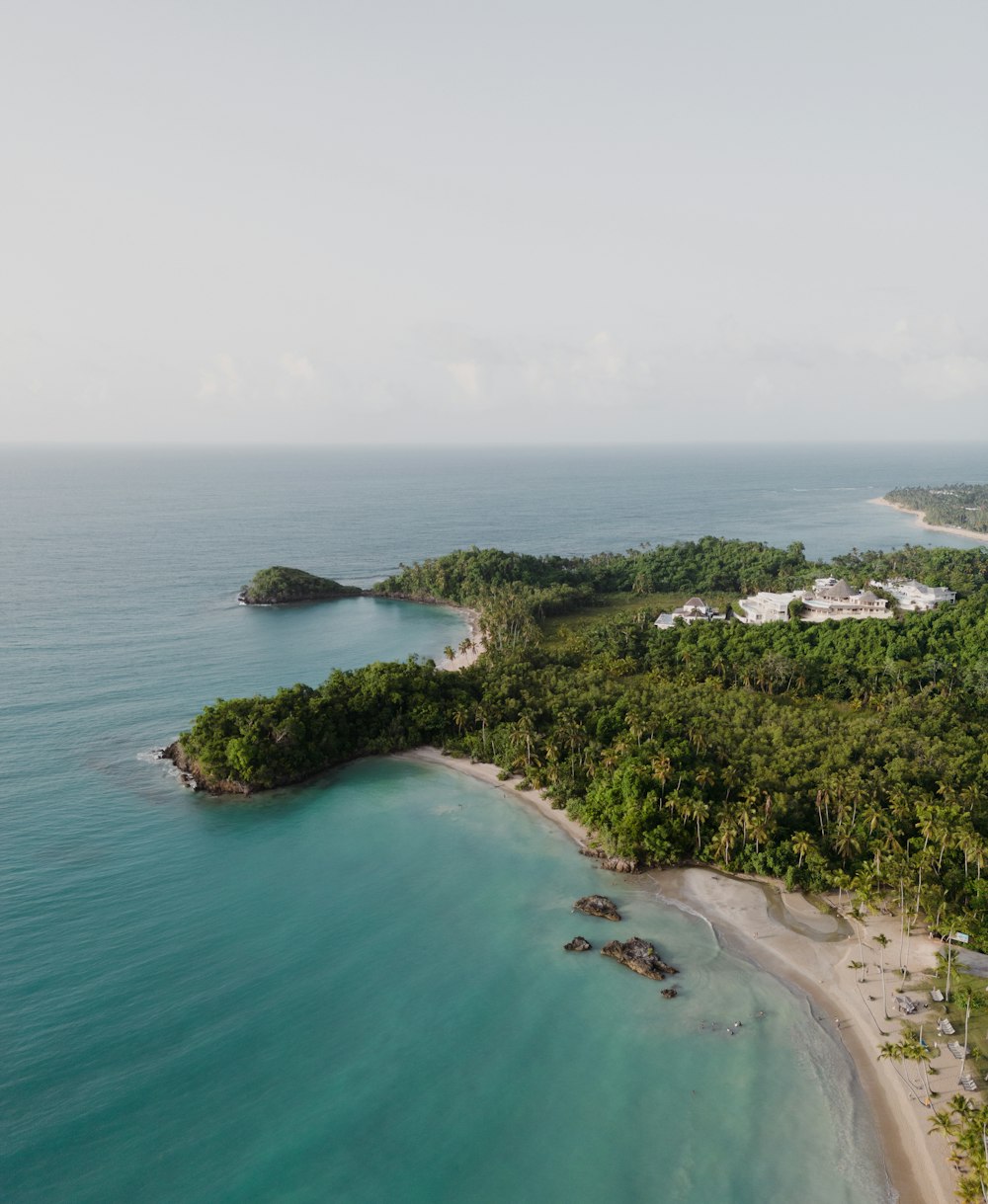 an aerial view of a tropical island with a sandy beach