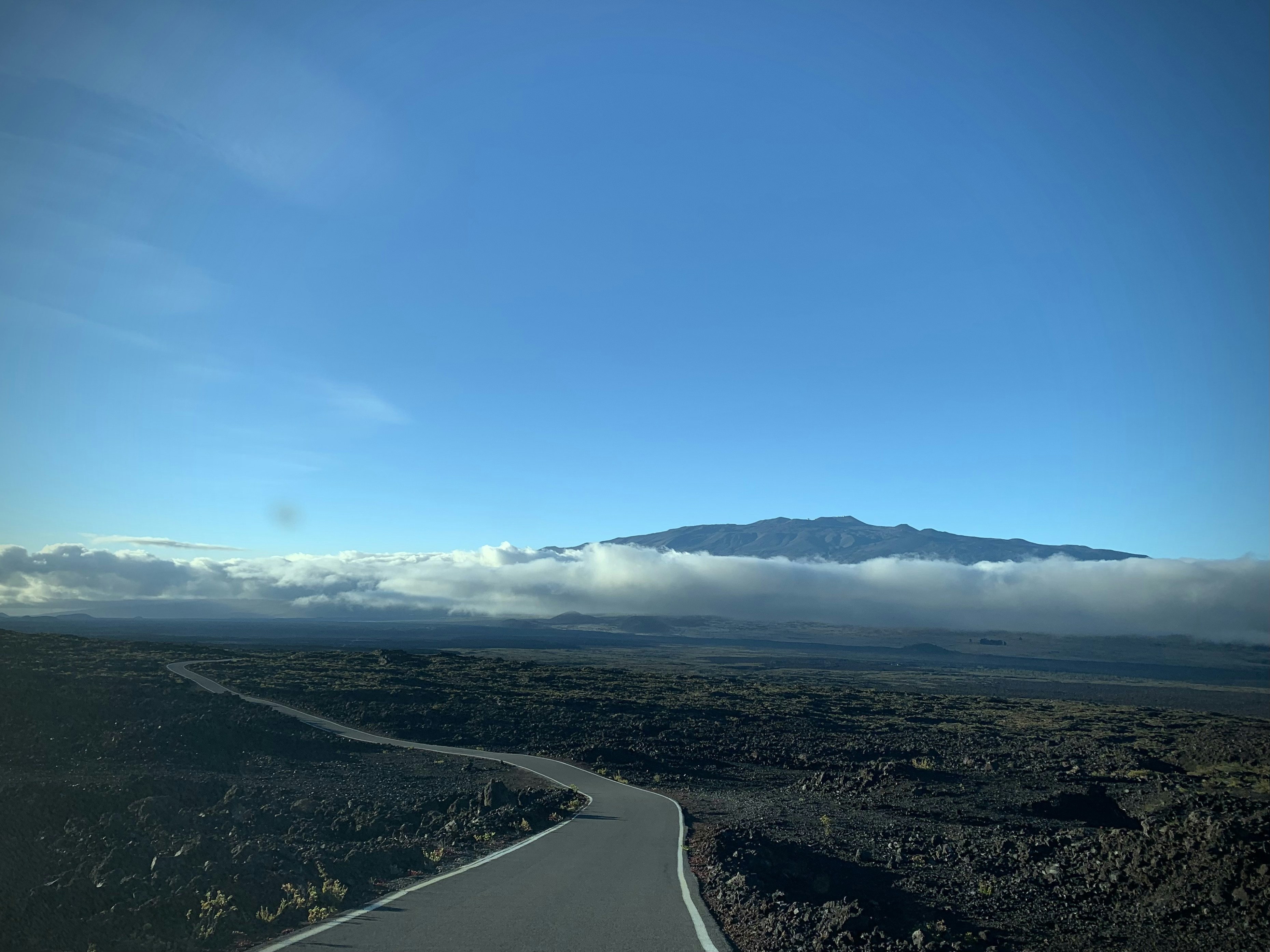 a view of a road with a mountain in the background