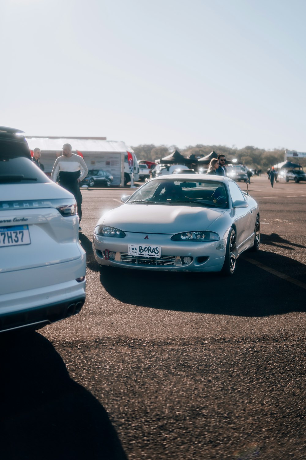 a white sports car parked in a parking lot