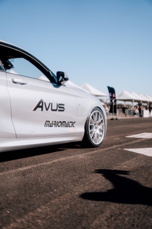 A fleet of sleek transport vehicles lined up under a clear sky, branded with navy and electric blue.