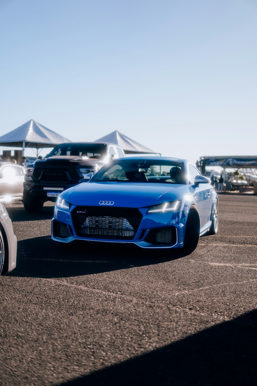 a blue sports car parked in a parking lot