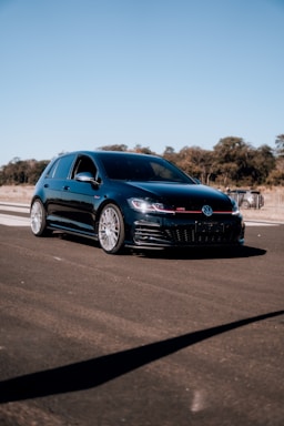 Side profile of a compact hatchback with shiny paint and clean tires