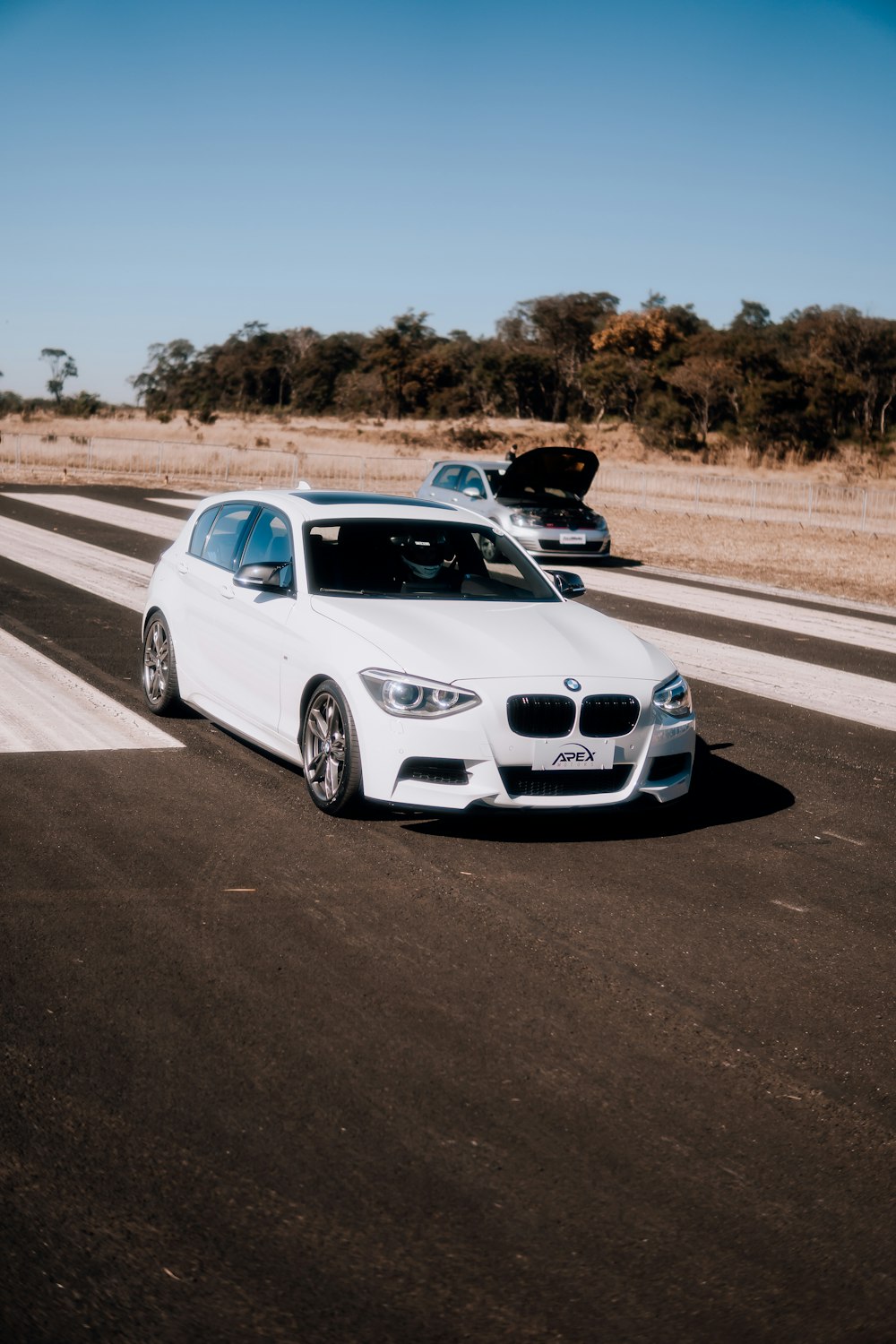 a white car parked on the side of the road