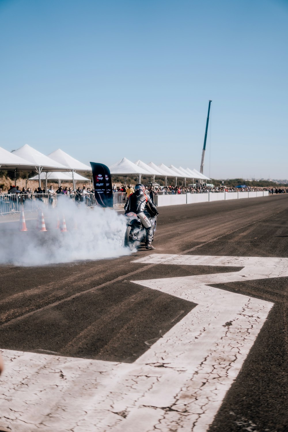 a man riding a motorcycle on top of a dirt track