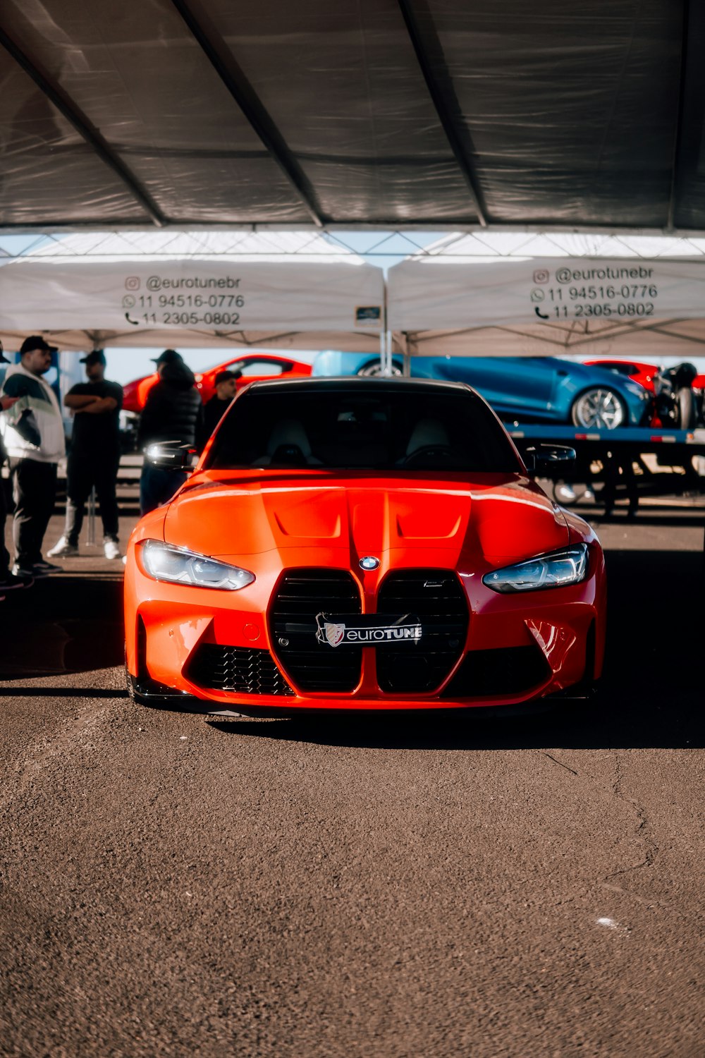 an orange sports car parked in a parking lot