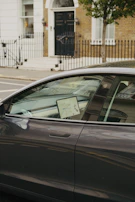 Technician carefully programming a modern car key with specialized equipment in Warsaw.