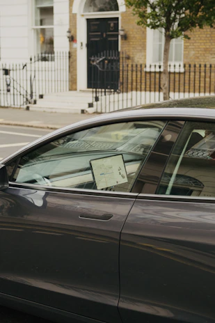 Vehicle on a city street with a digital map overlay showing real-time tracking.