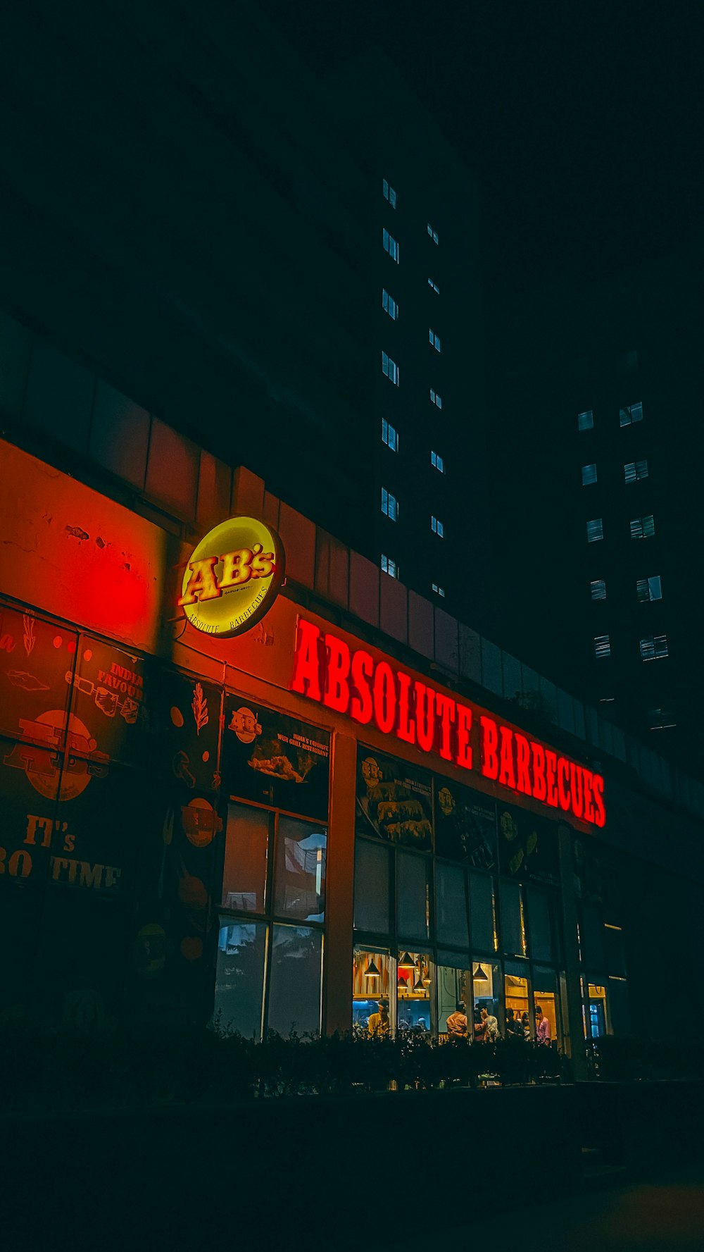 a lit up barbeque at night in a city