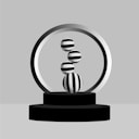 a black and white photo of a ball on a stand