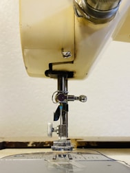 Detailed view of sewing machine parts laid out for replacement.