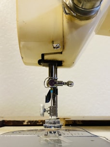 Detailed view of sewing machine parts laid out for replacement.