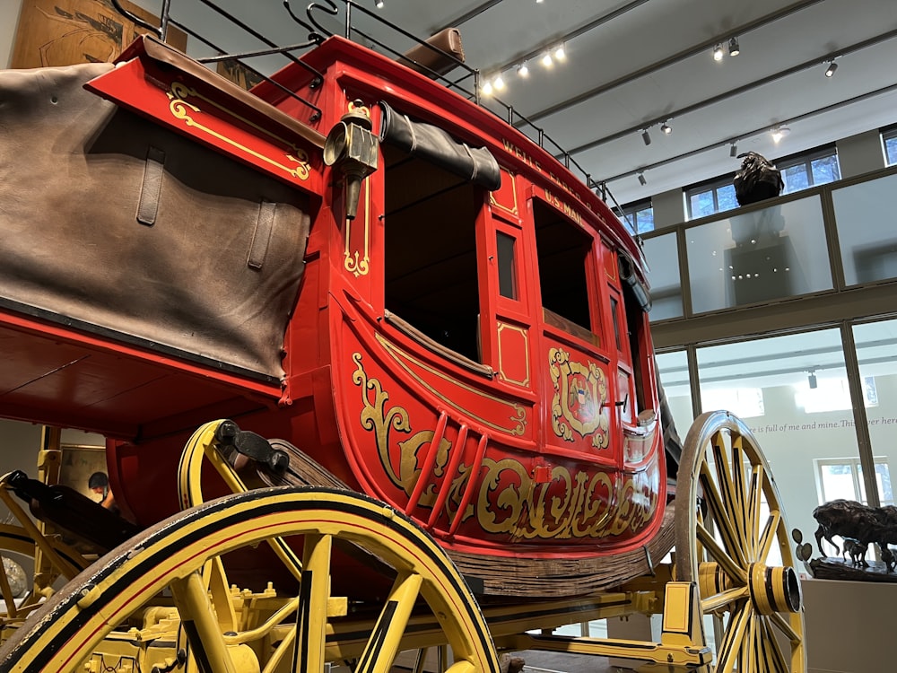 a large red and yellow horse drawn carriage