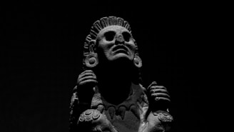 Abstract stone sculpture with gold accents reflecting Andean mountain shapes.
