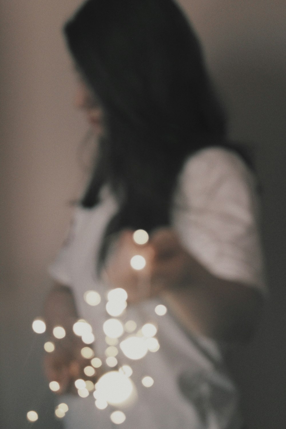 a woman holding a sparkler in her hands