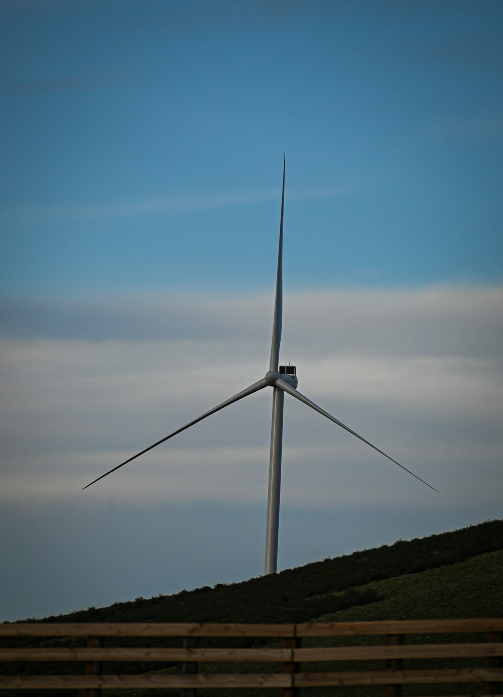 a wind turbine on top of a hill