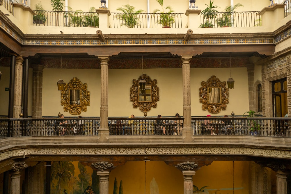 a large building with a balcony and several mirrors on the wall