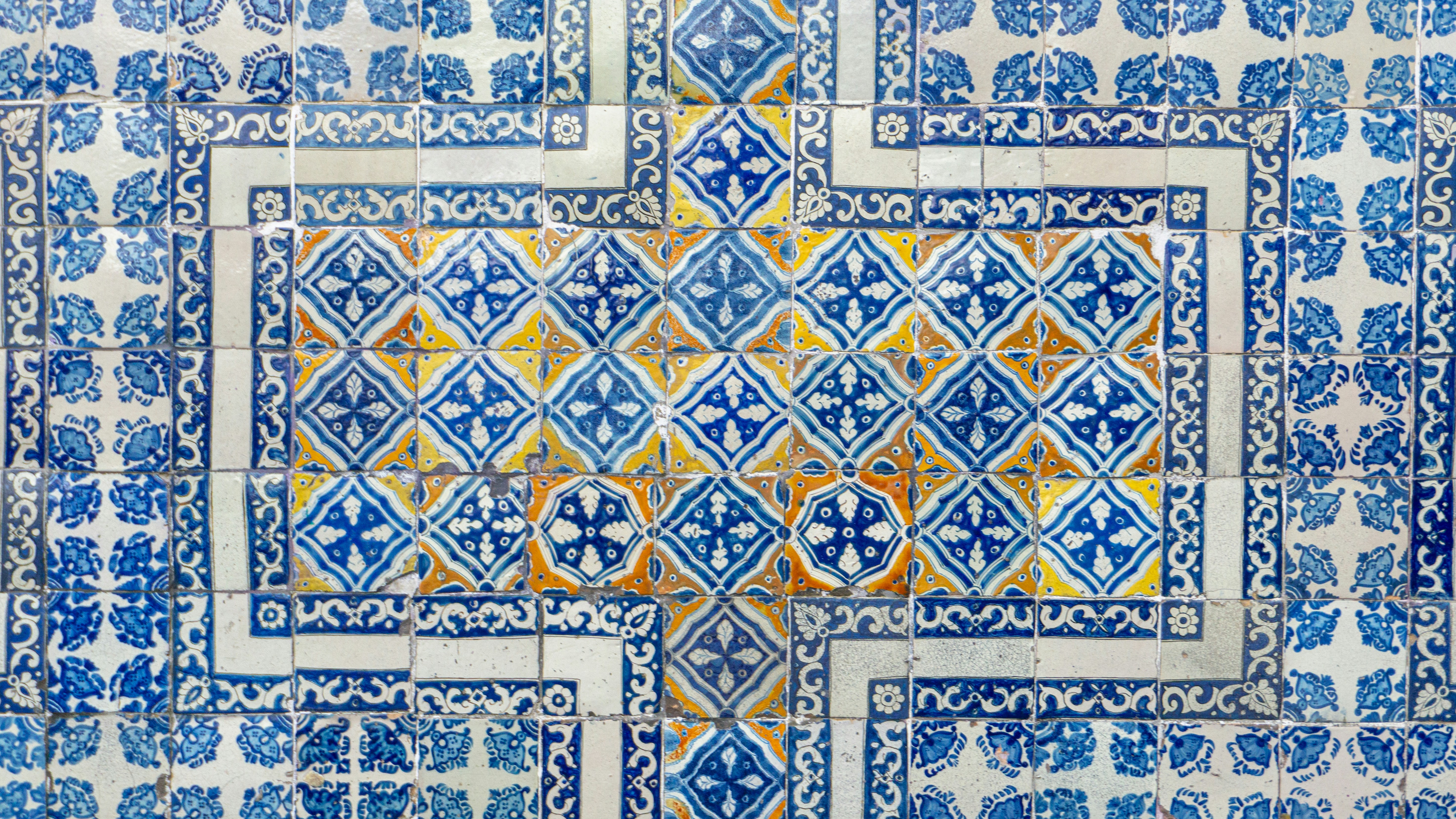 a blue and white tile wall with an intricate design
