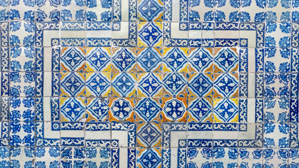 a blue and white tile wall with an intricate design