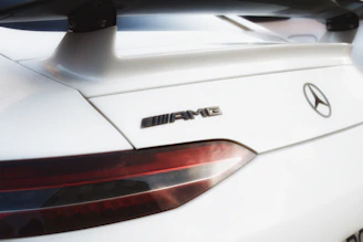 Side view of a Mercedes Benz with a smooth facelift, highlighting shiny new body kit parts.