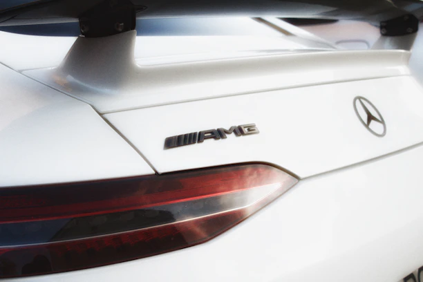 Side view of a Mercedes Benz with a smooth facelift, highlighting shiny new body kit parts.