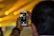 A close-up of a photographer capturing a moment at a vibrant outdoor event.