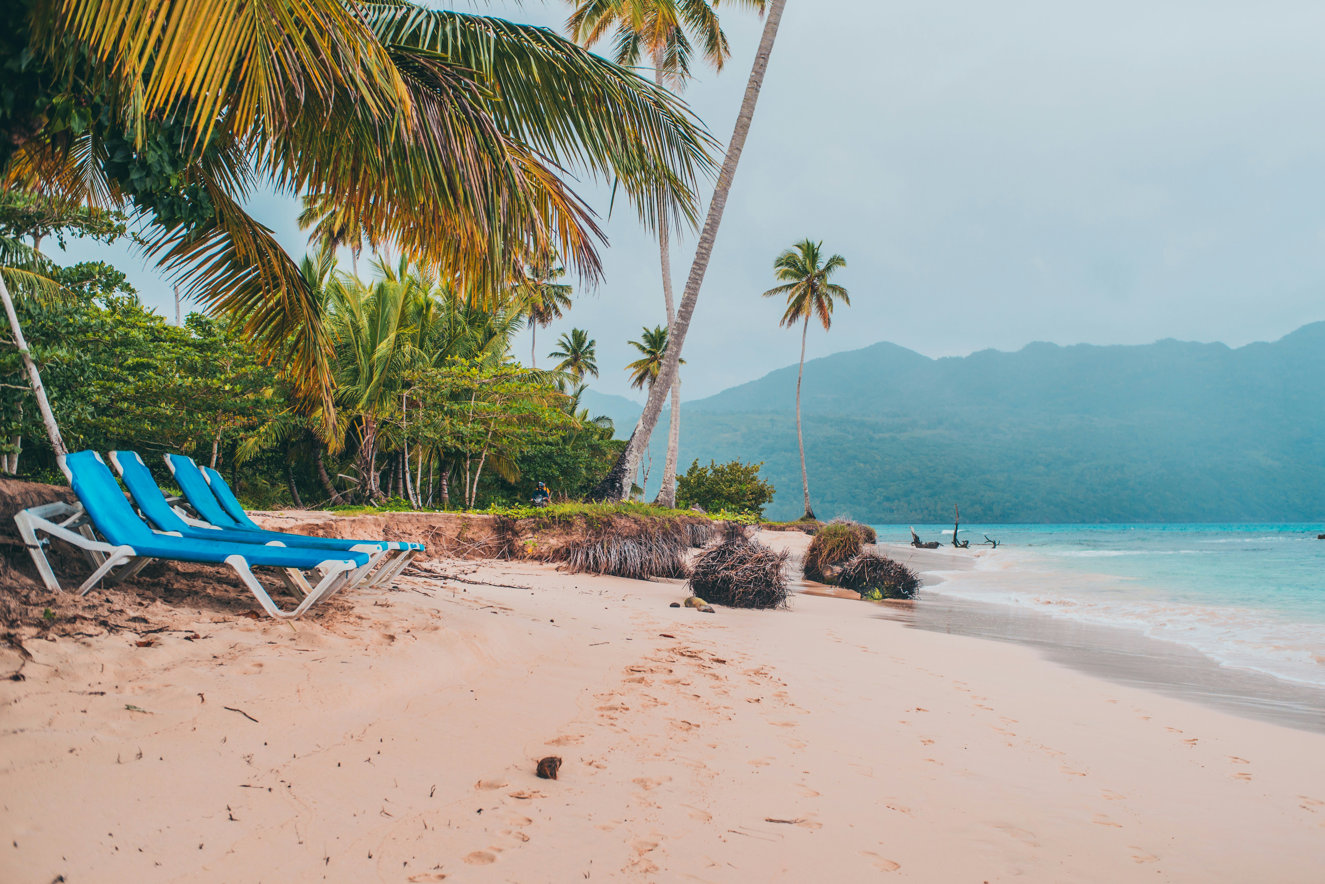 A blue lawn chair sitting on top of a sandy beach photo – Free Fun ...