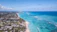 Aerial view of Cabo Frio's coastline with turquoise waters and sandy beaches under a clear sky.