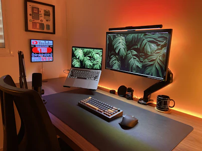 a desk with a laptop and a monitor on it