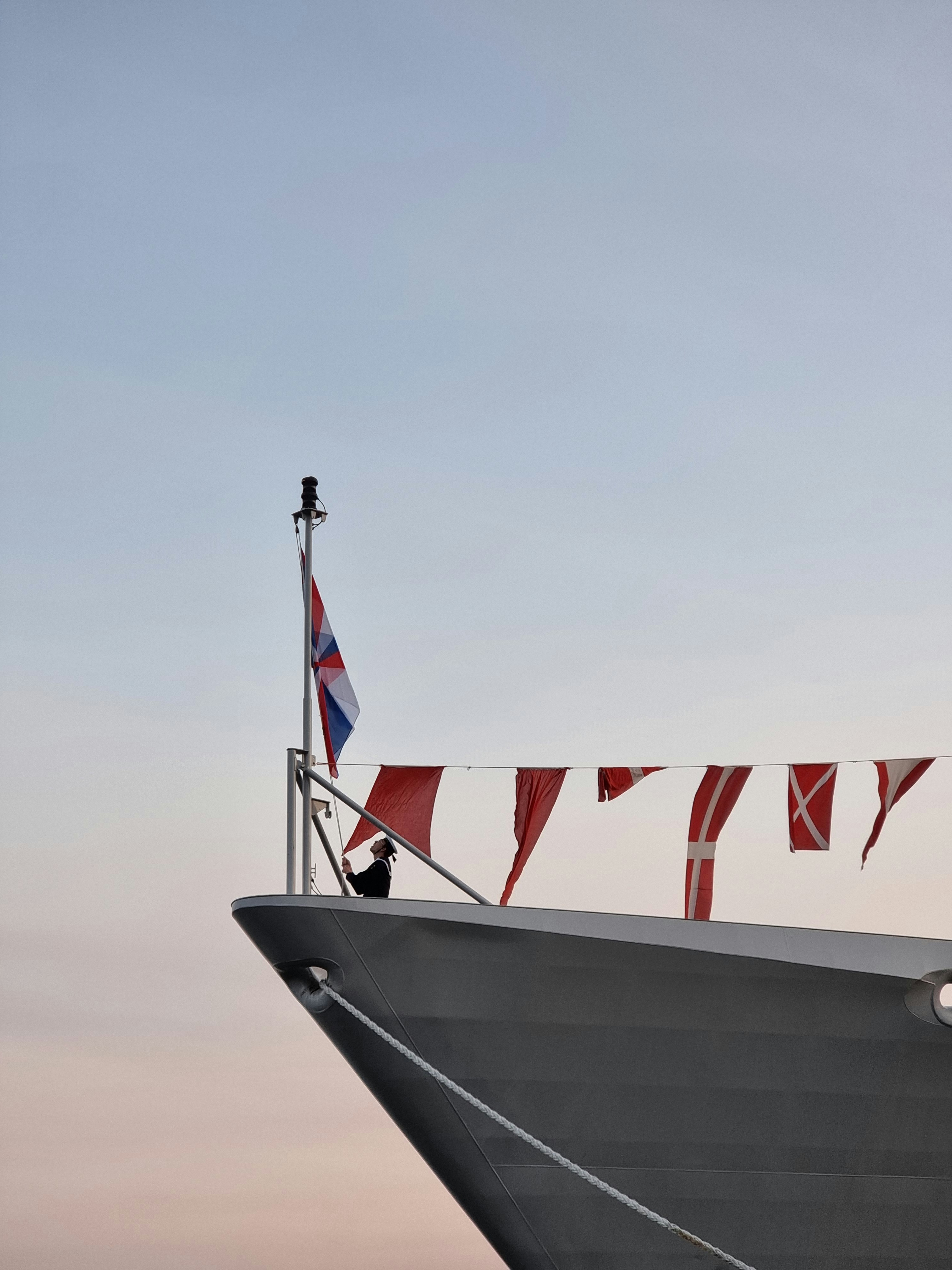 a large boat with flags on the side of it
