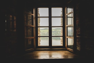 an open window with a view of a lake