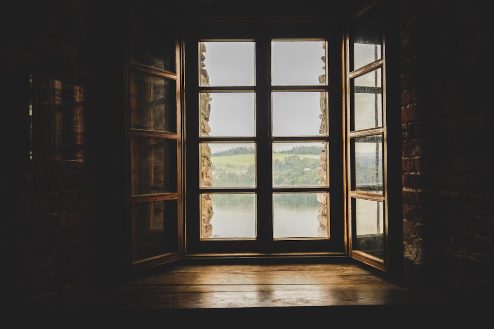 an open window with a view of a lake