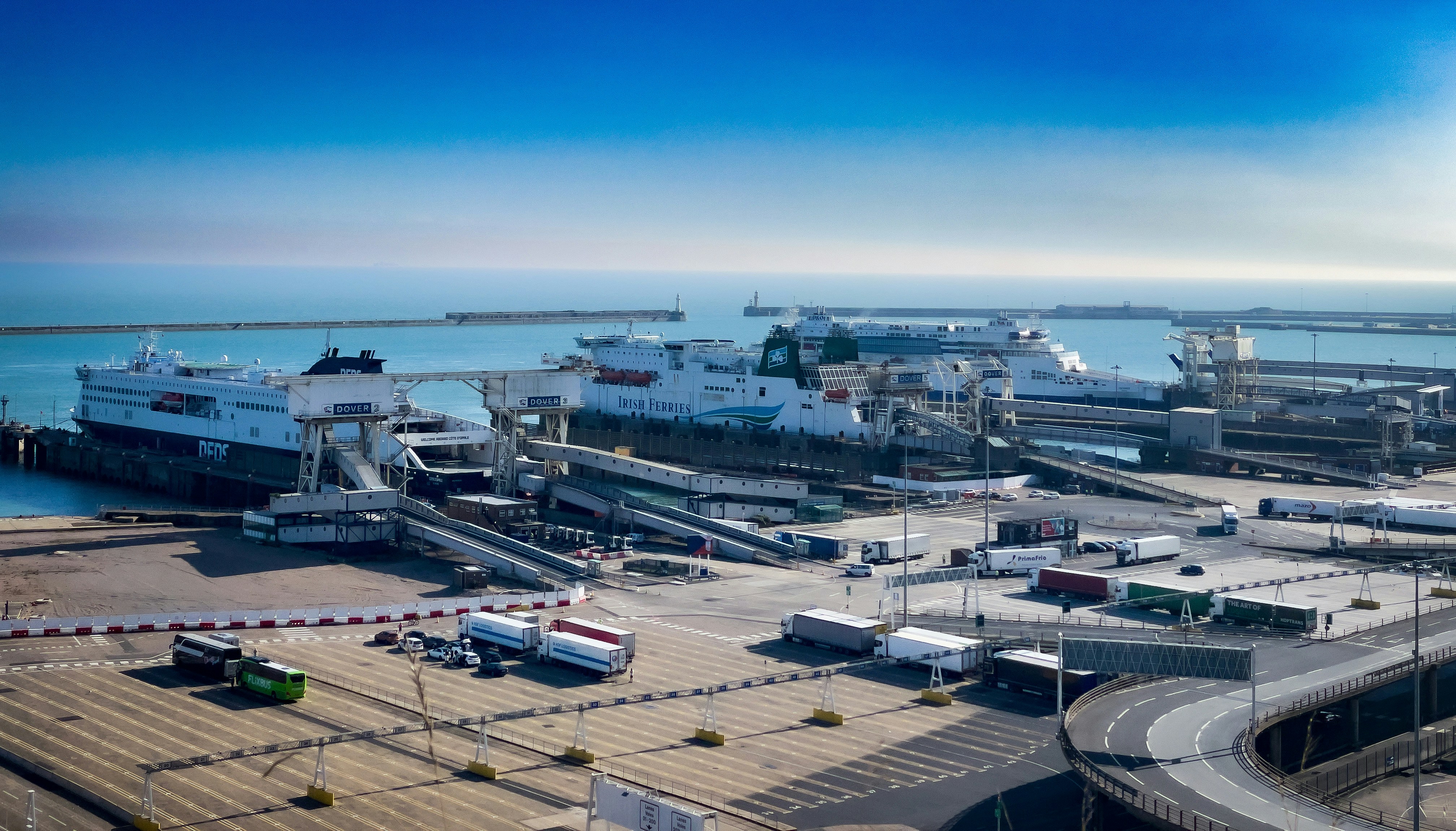 a harbor filled with lots of boats next to a large body of water